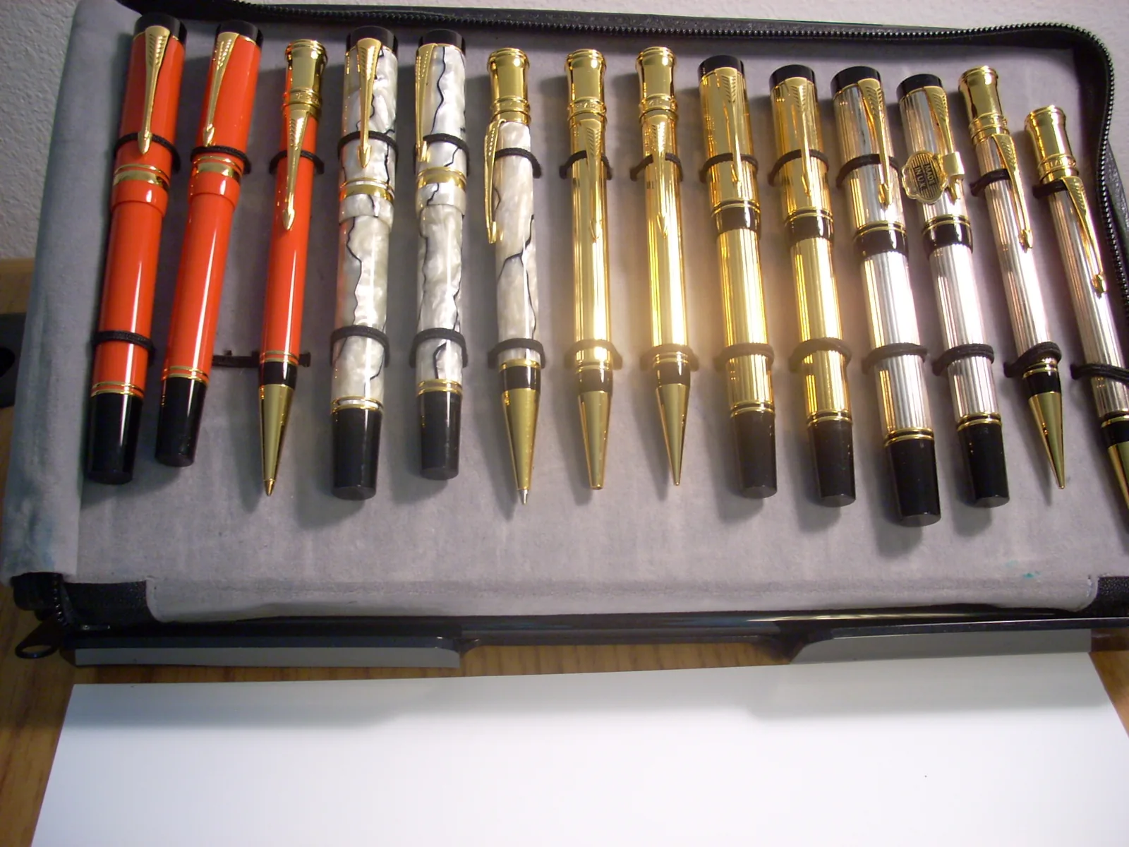 Collection tray filled with fine writing instruments in red, pearl, gold and silver finishes