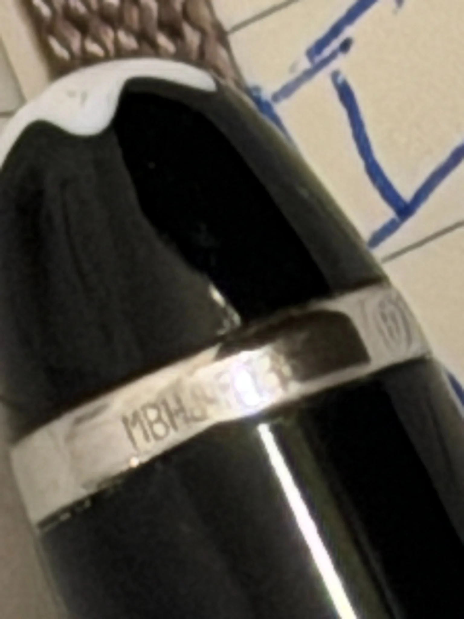 Close-up of engraved markings on a black fountain pen cap band