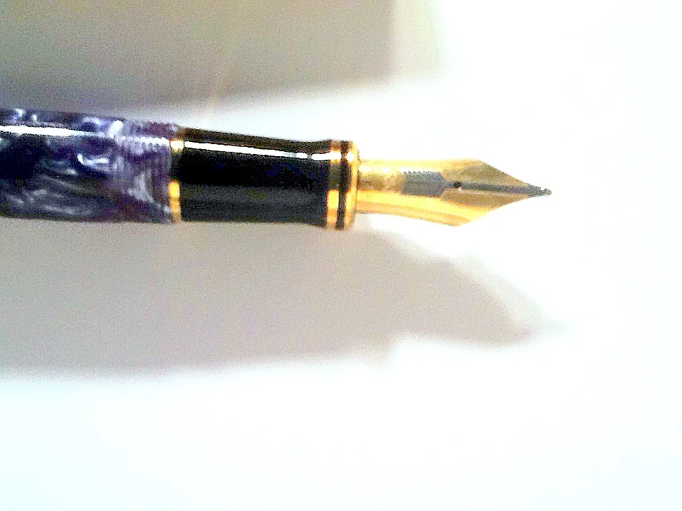 Blue Parker Duofold fountain pen shown capped against a neutral background